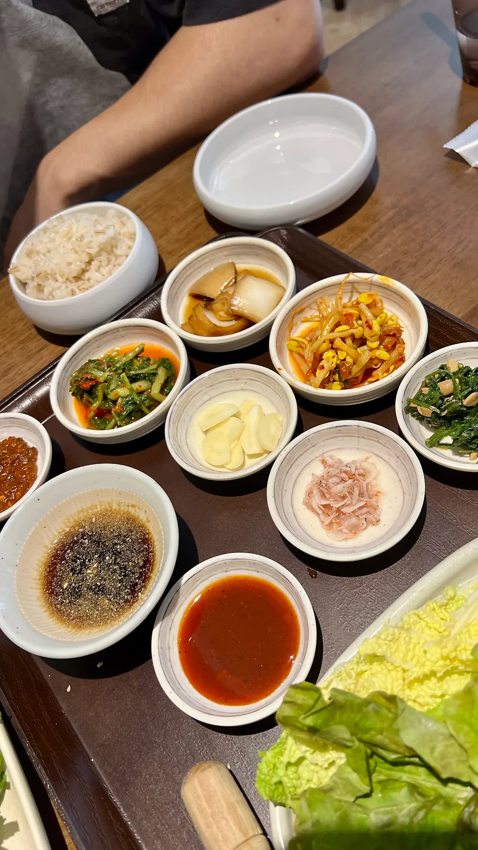 Side dish plates including yeolmu kimchi and seasoned bean sprouts