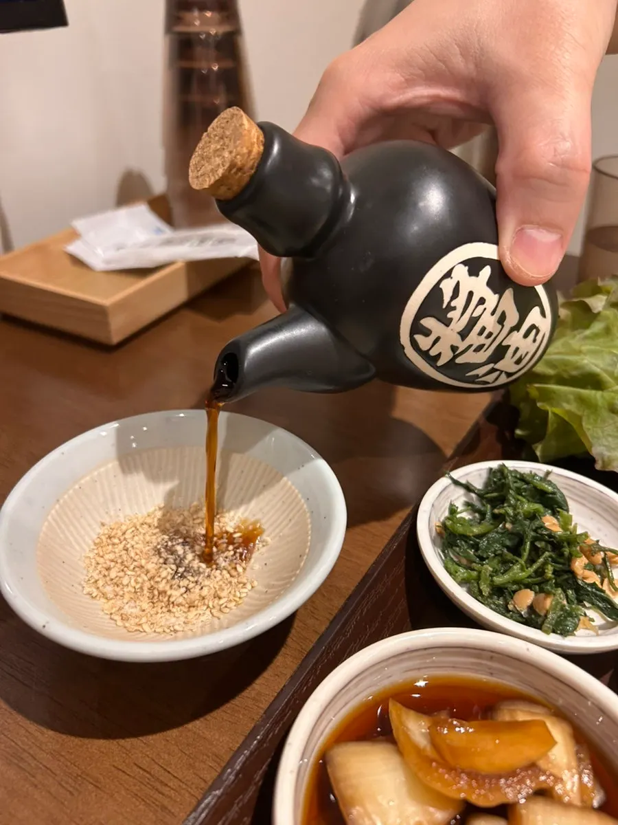 Sesame soy sauce and spicy sauce set on the table