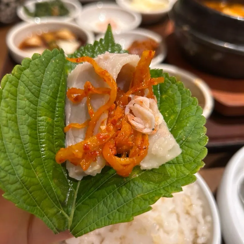 Bossam wrap topped with minari