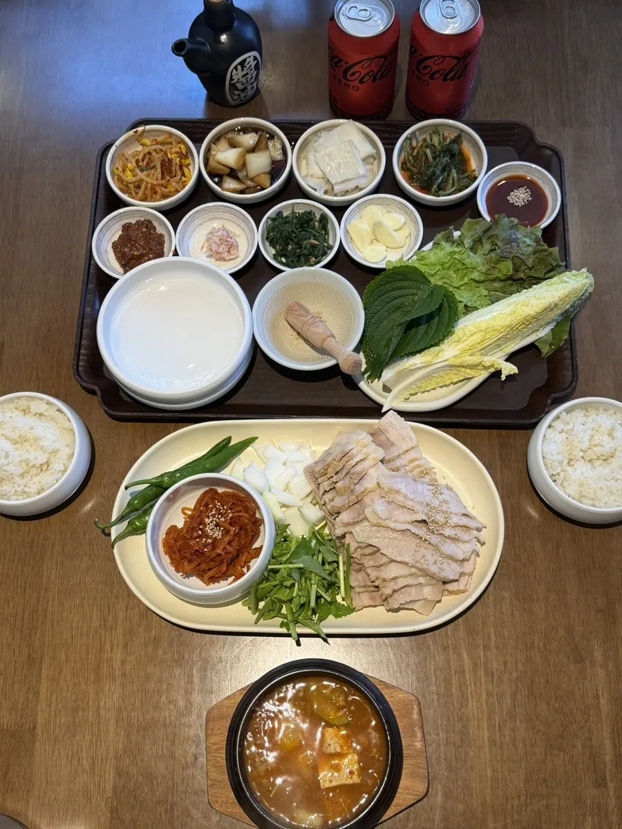 Bossam, lettuce wraps, doenjang jjigae, and side dishes