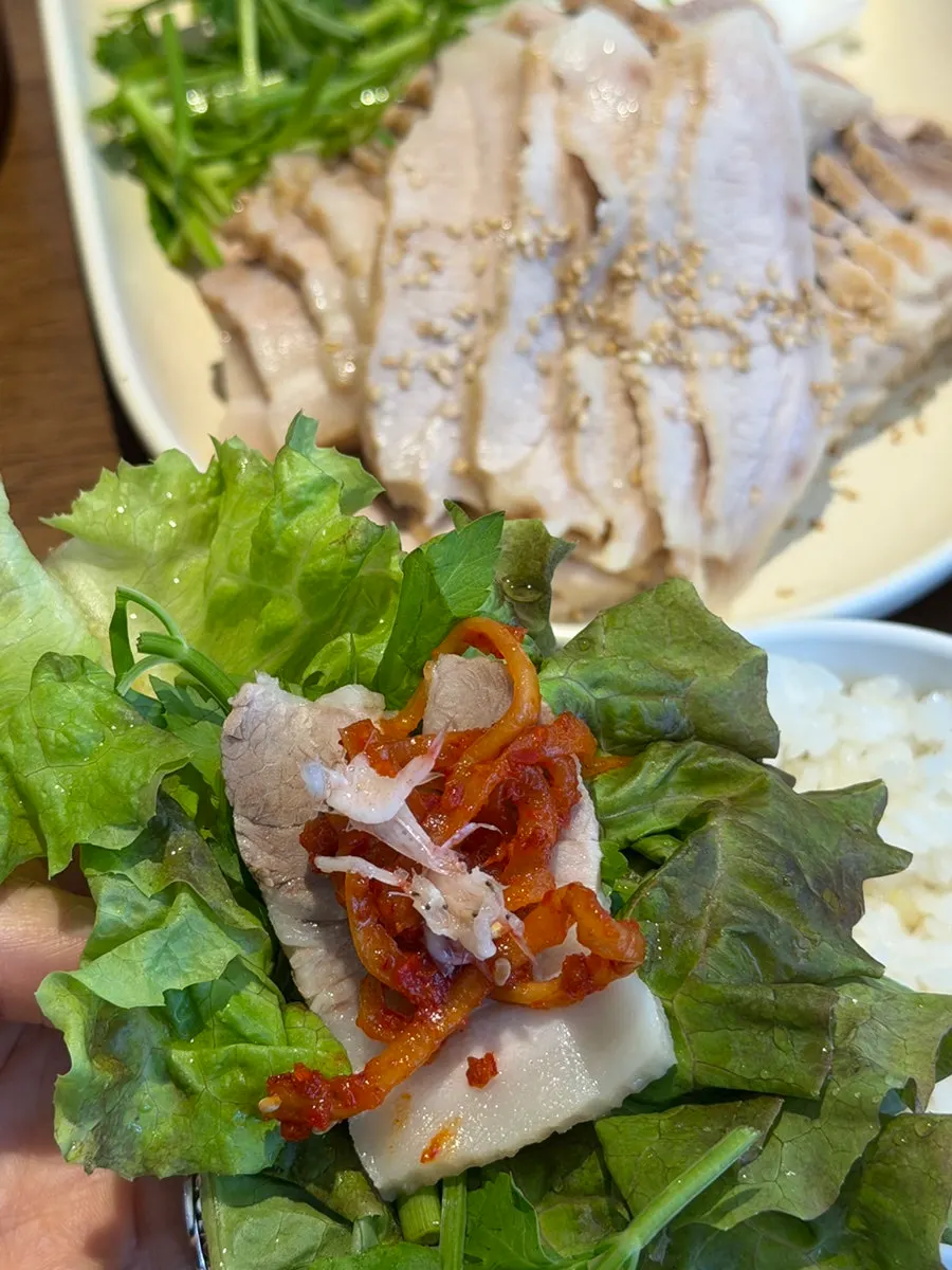 Bossam pork and radish kimchi in a lettuce wrap