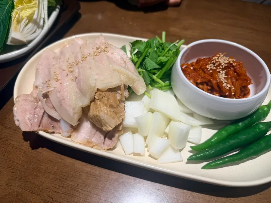 Bossam side dishes including minari and radish salad