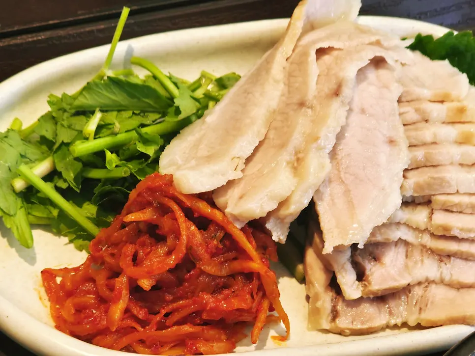따뜻한 밥과 뜨거운 된장찌개가 놓인 보쌈 한상