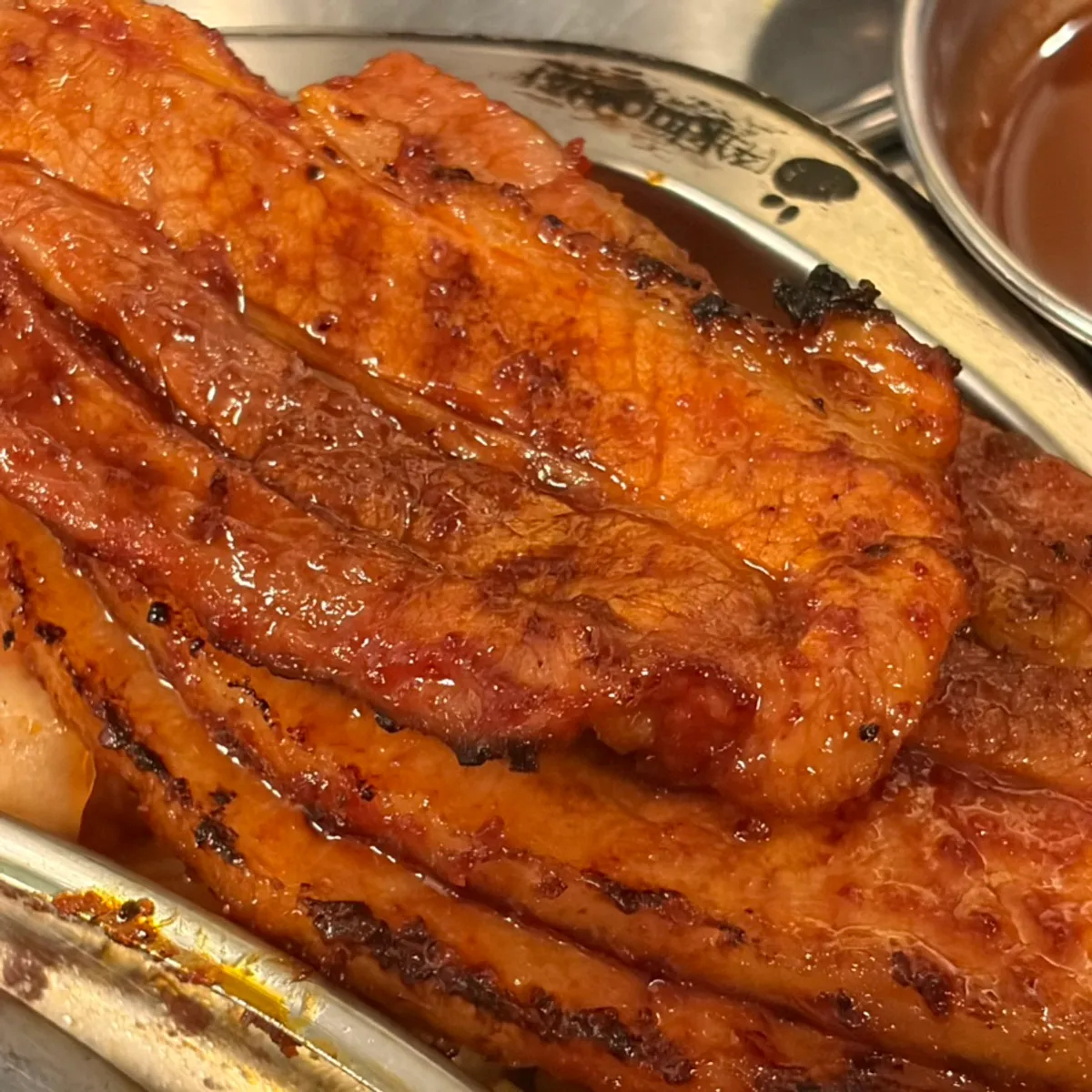 Gochujang pork belly grilling on the charcoal grill
