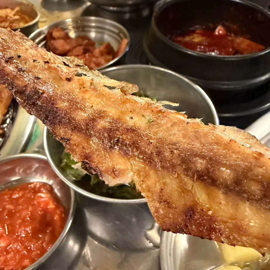 Grilled mackerel flesh picked off and dipped in chili sauce