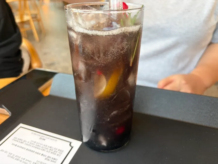 MUG lemonade topped with lemon and thyme