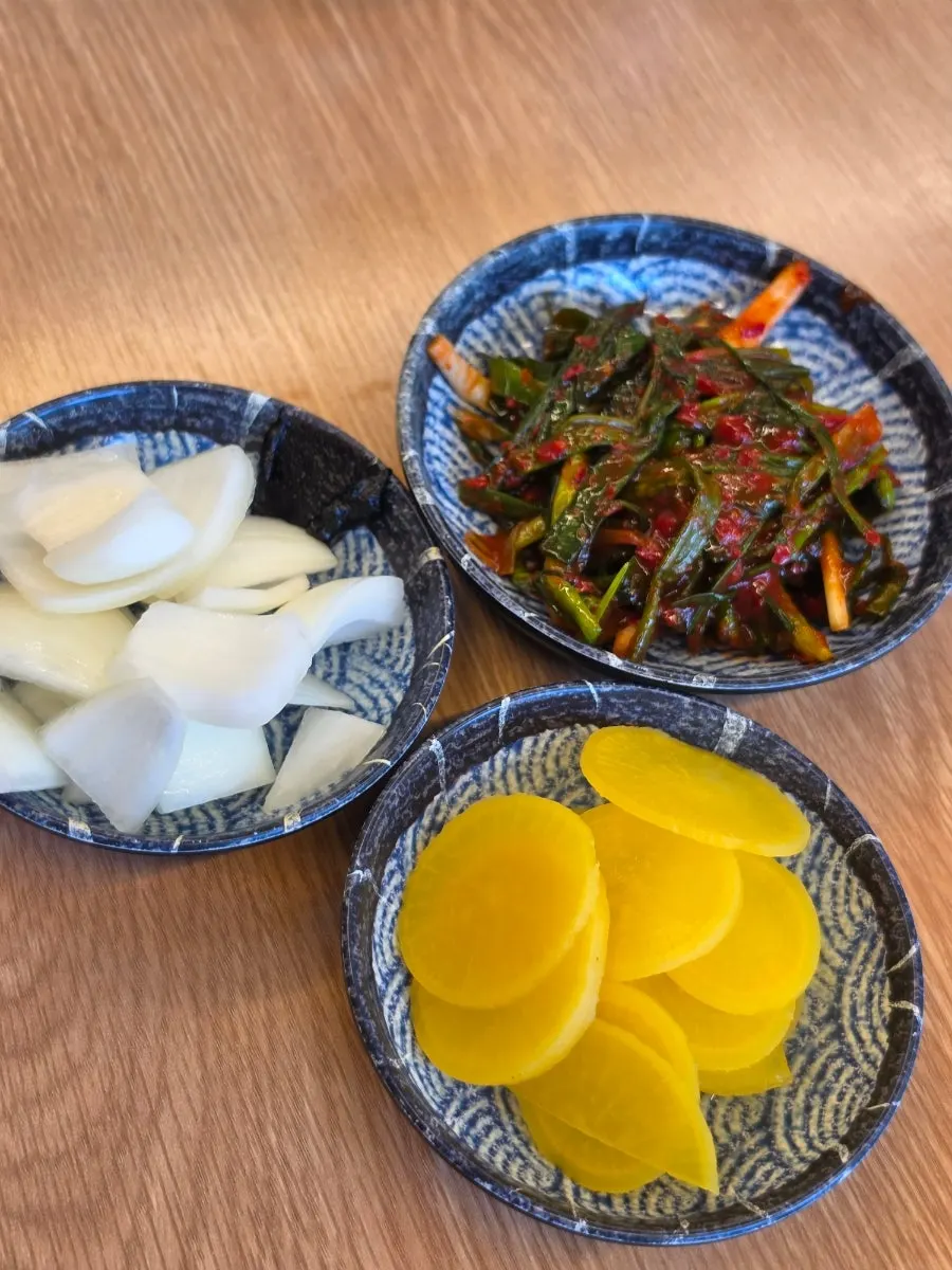 Green onion kimchi, onions, and pickled radish served as basic side dishes