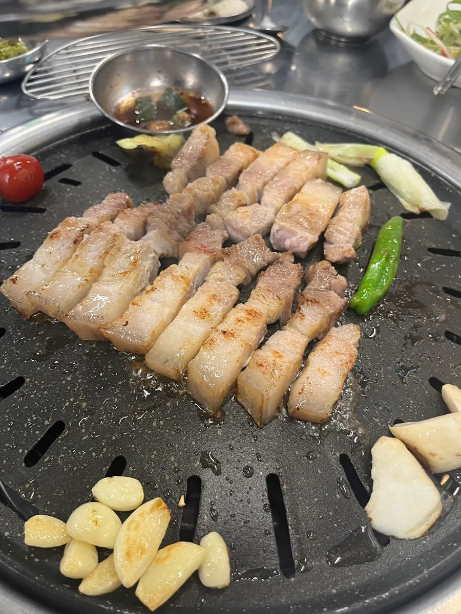 Table spread of Gimcheon black pork charcoal barbecue at Daewol Charcoal Barbecue