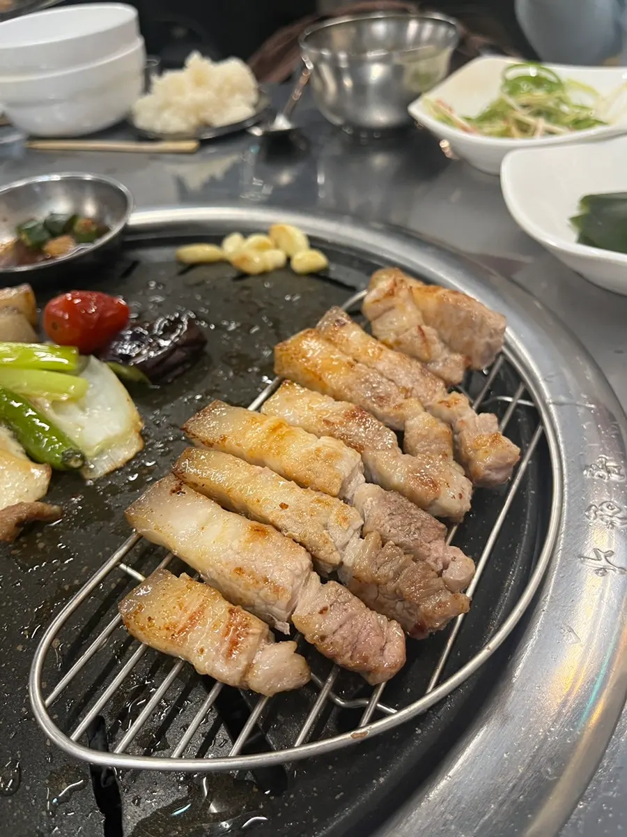 Black pork belly and rice wrapped in a lettuce leaf