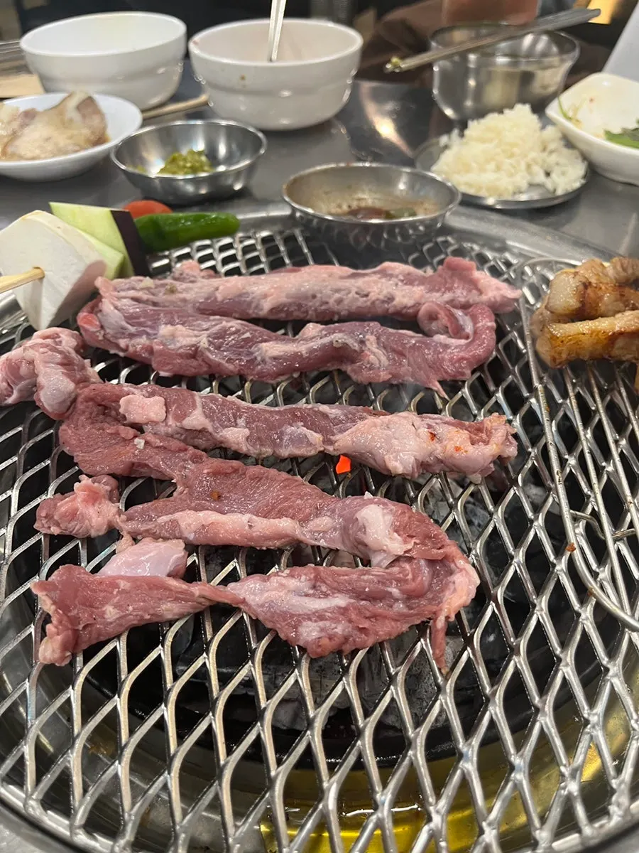 Raw galmaegisal placed on the charcoal grill