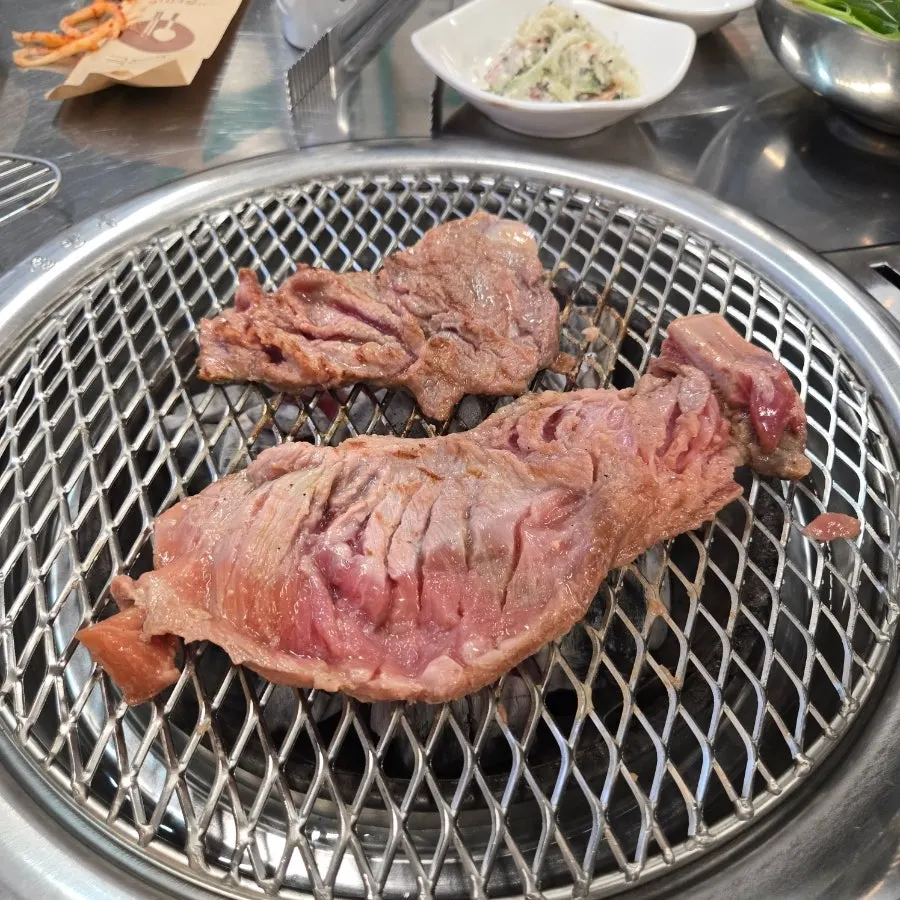 Black pork marinated ribs grilling directly on the coals
