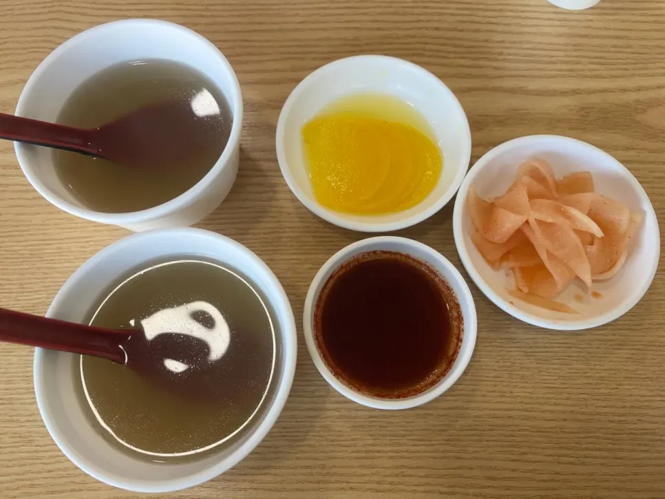 Warm broth and basic table setting served first