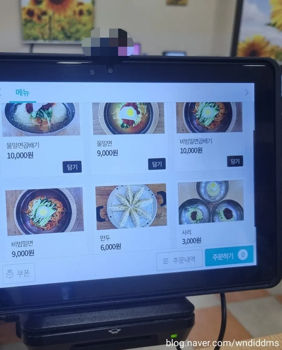 Menu board listing water milmyeon and bibim milmyeon prices