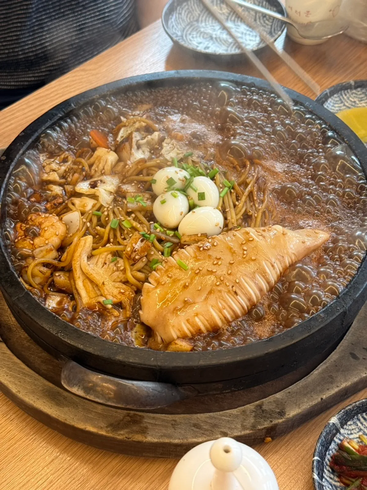 Stone-plate dol jjajang topped with a whole squid