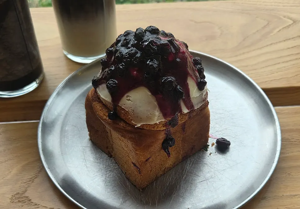 A plate of blueberry cream cheese cinnamon roll