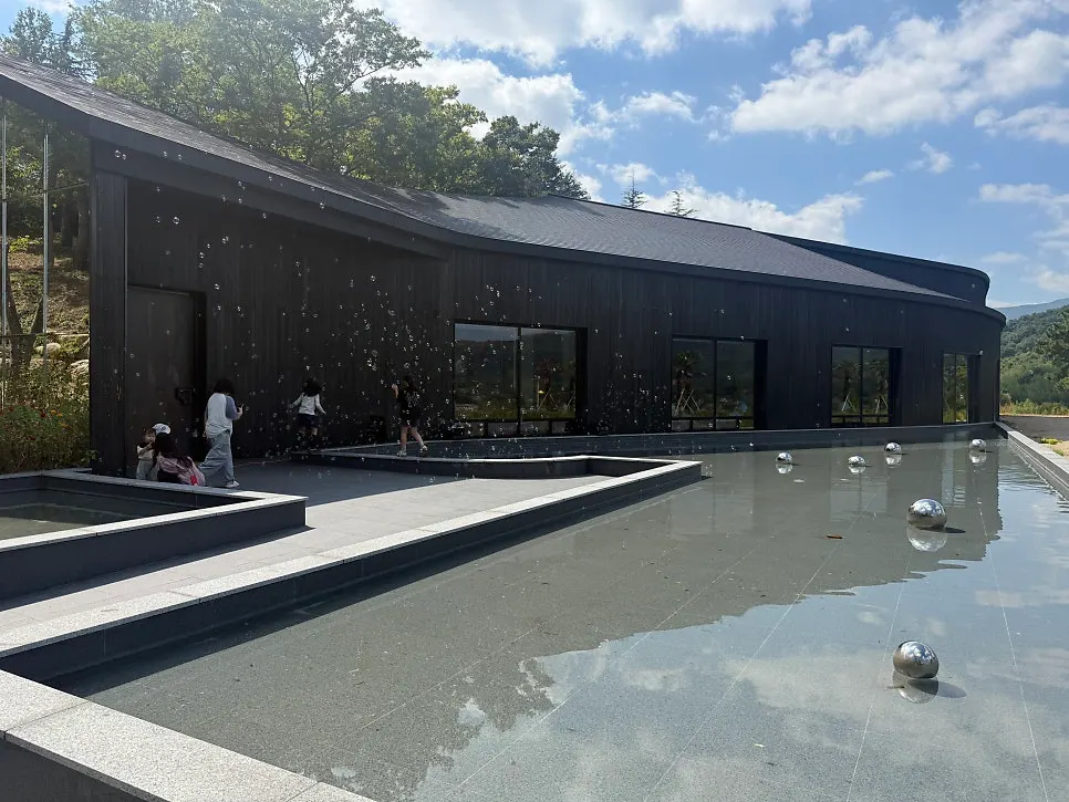 MUG's exterior featuring striking black wood