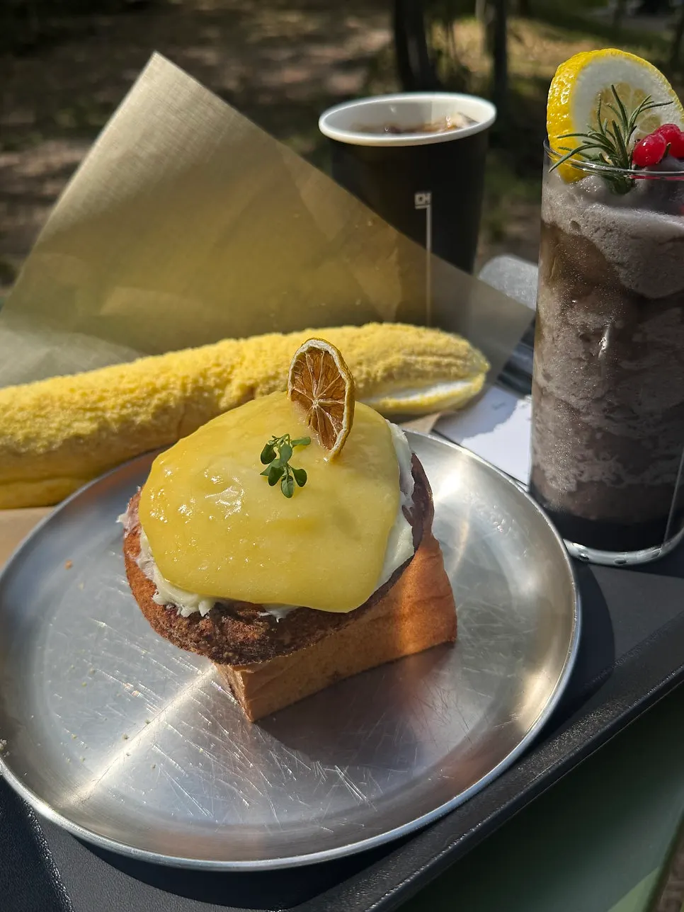 Cinnamon roll placed on an outdoor table at MUG