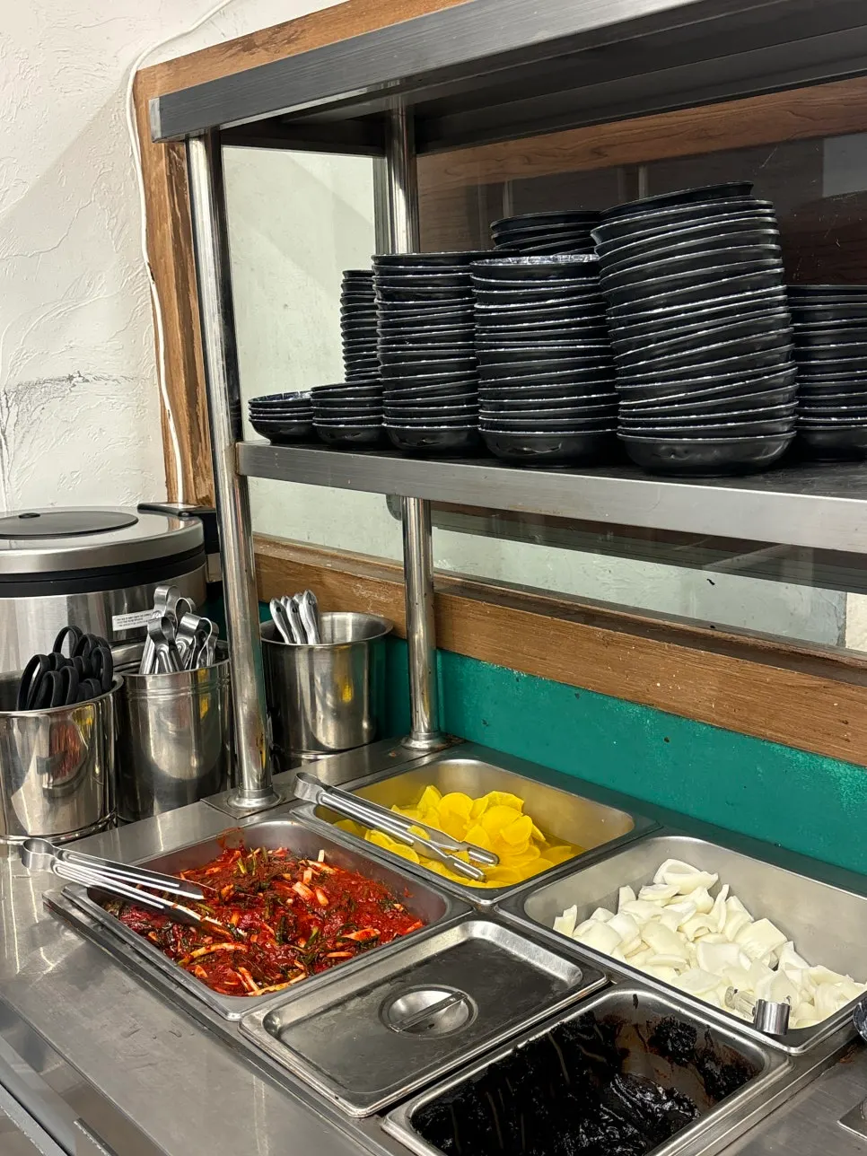 Self-serve bar with green onion kimchi and pickled radish