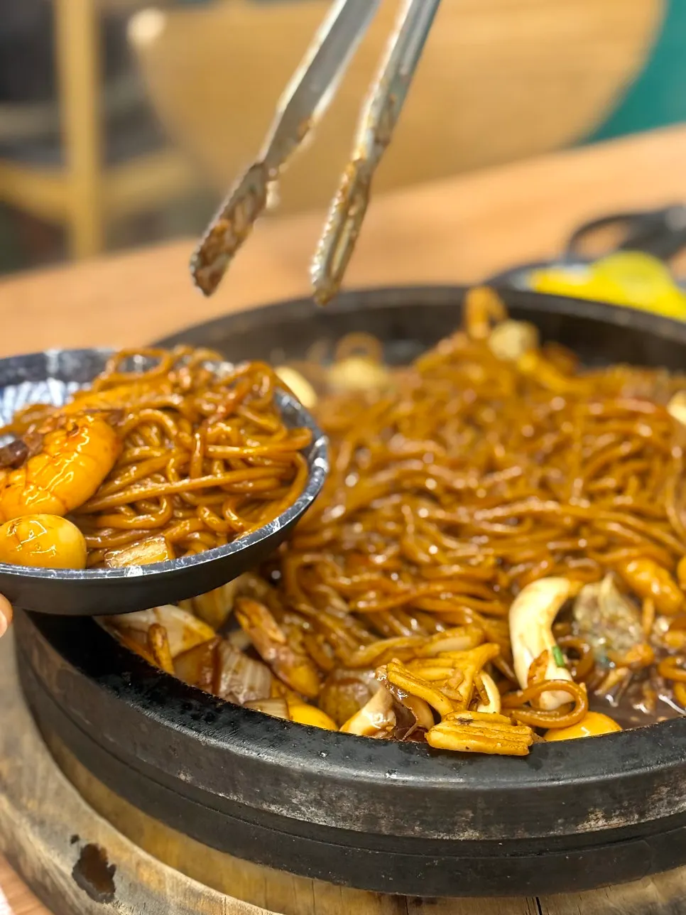 Close-up of stone-plate jjajang with shrimp and quail eggs visible