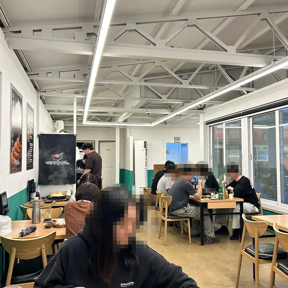 Dining hall seating with customers at Ulsan Daewangam Dol Jjamppong