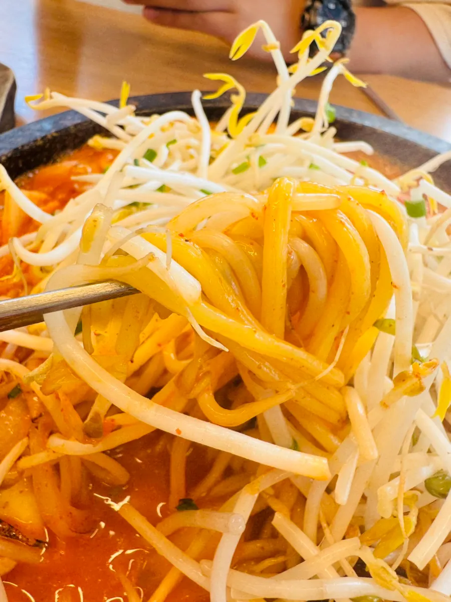 Scorched rice stone jjamppong topped with bean sprouts, squid, and mussels