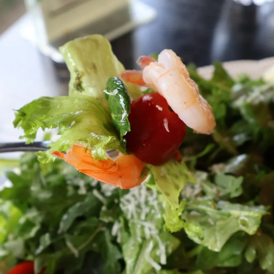 Salad topped with plump shrimp