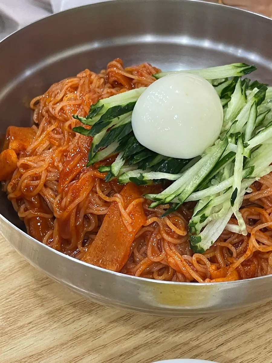 A bowl of mul-milmyeon with ice flakes floating on top