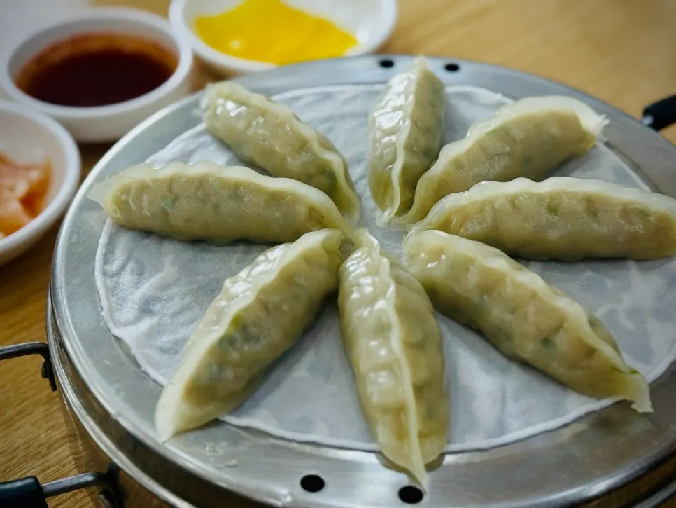 Warm dumplings served alongside mul milmyeon