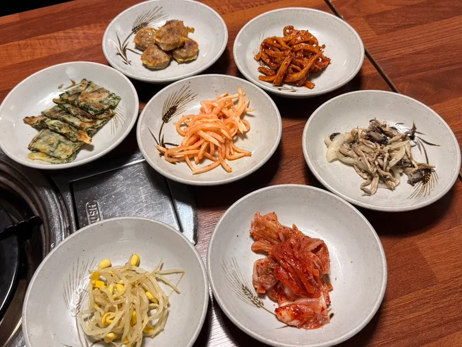 Table setting with spicy pork stir-fry and kimchi stew