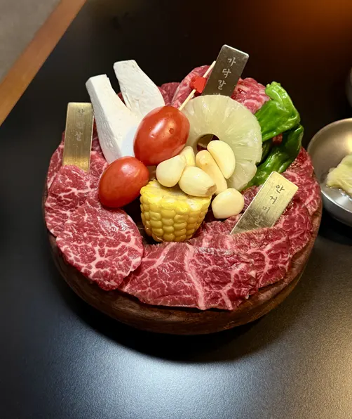 Three cuts of beef plated on the mixed platter