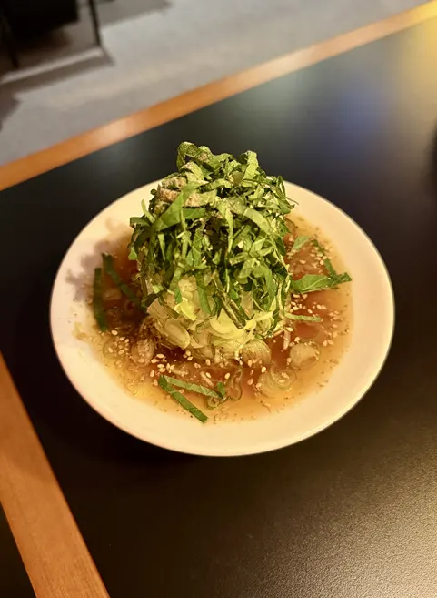 Green onion salad piled on top of the meat