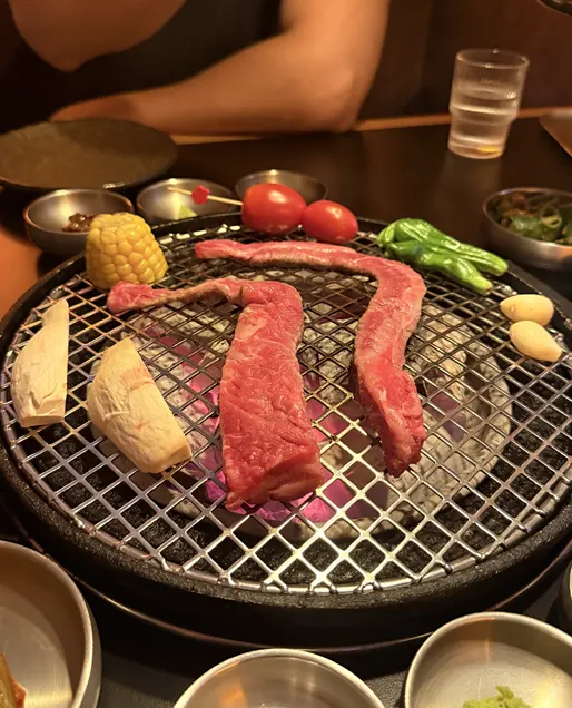 Beef grilling over charcoal