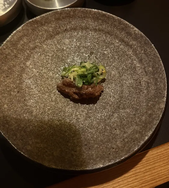 A bite of meat wrapped with green onion