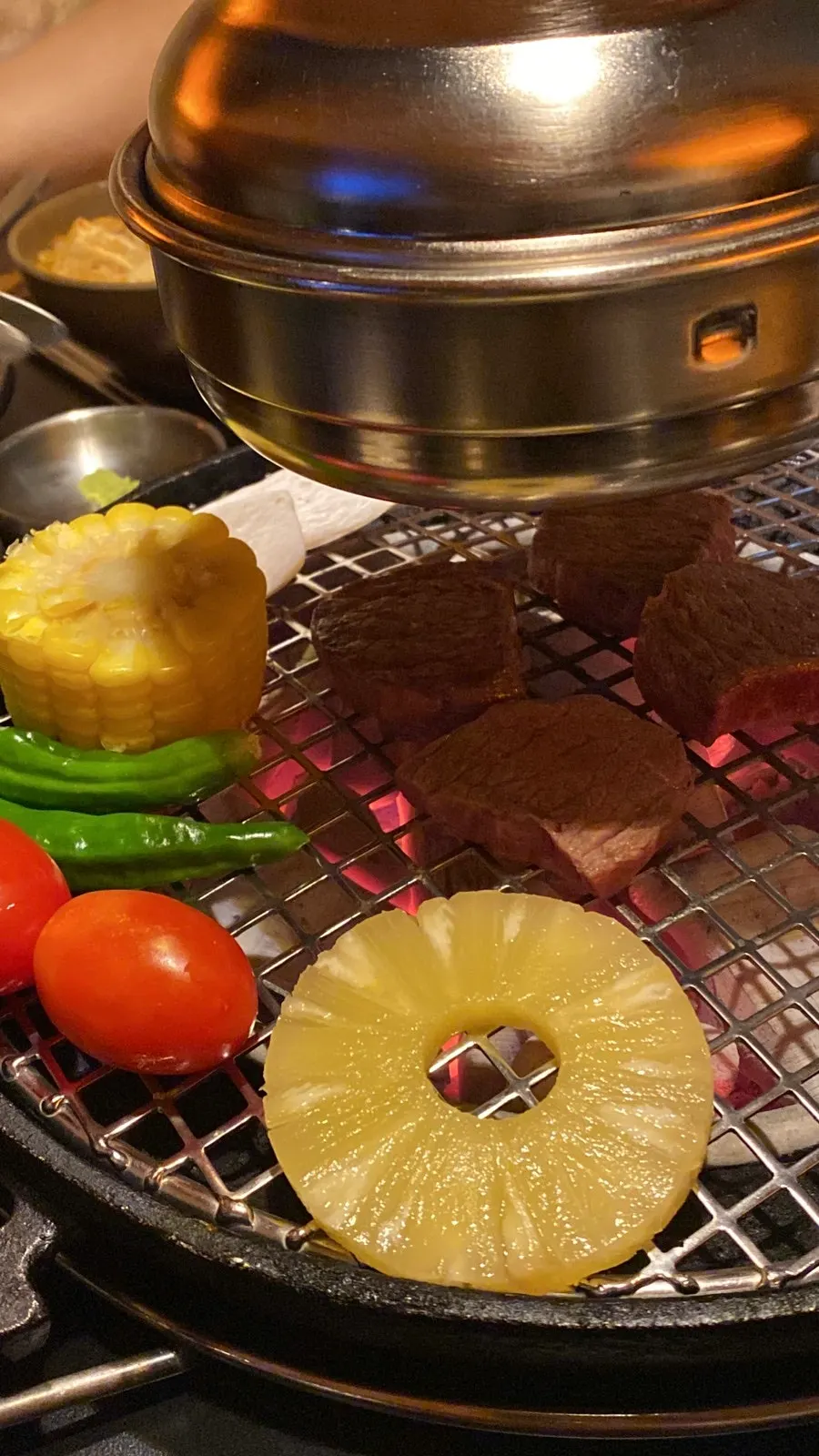 Chamjinsal cooking on the charcoal grill
