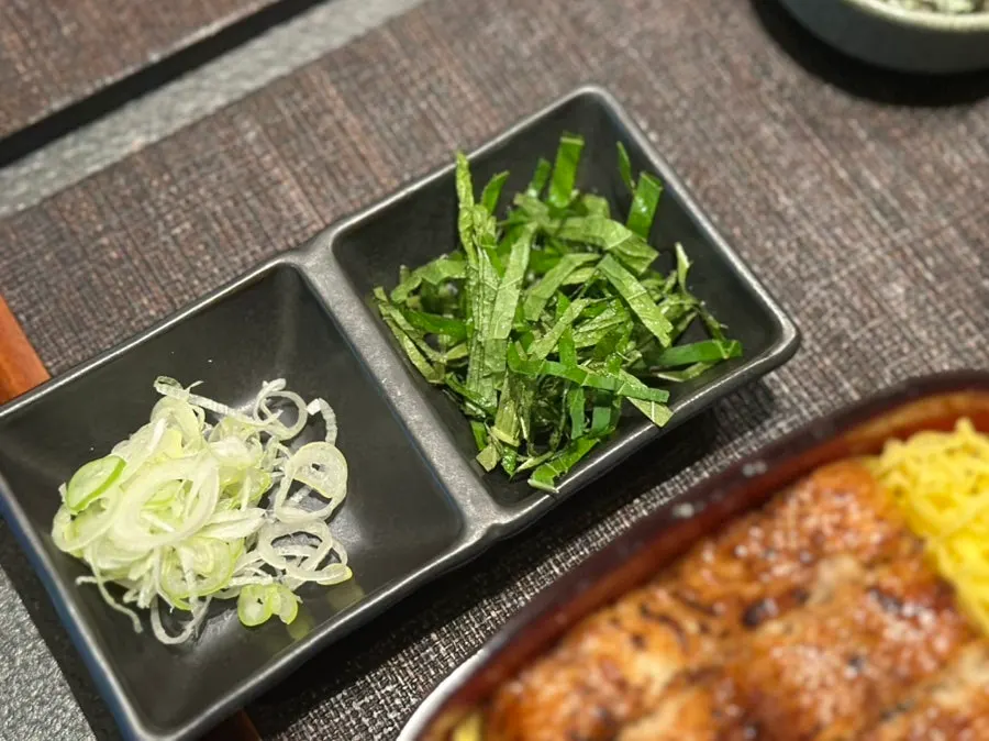Scallions, perilla leaves, seaweed flakes, wasabi, and pickled side dishes