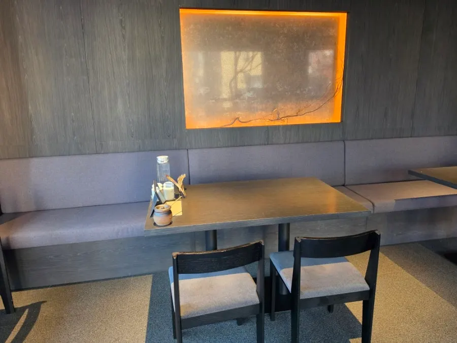Kitchen visible through the glass, grilling eel