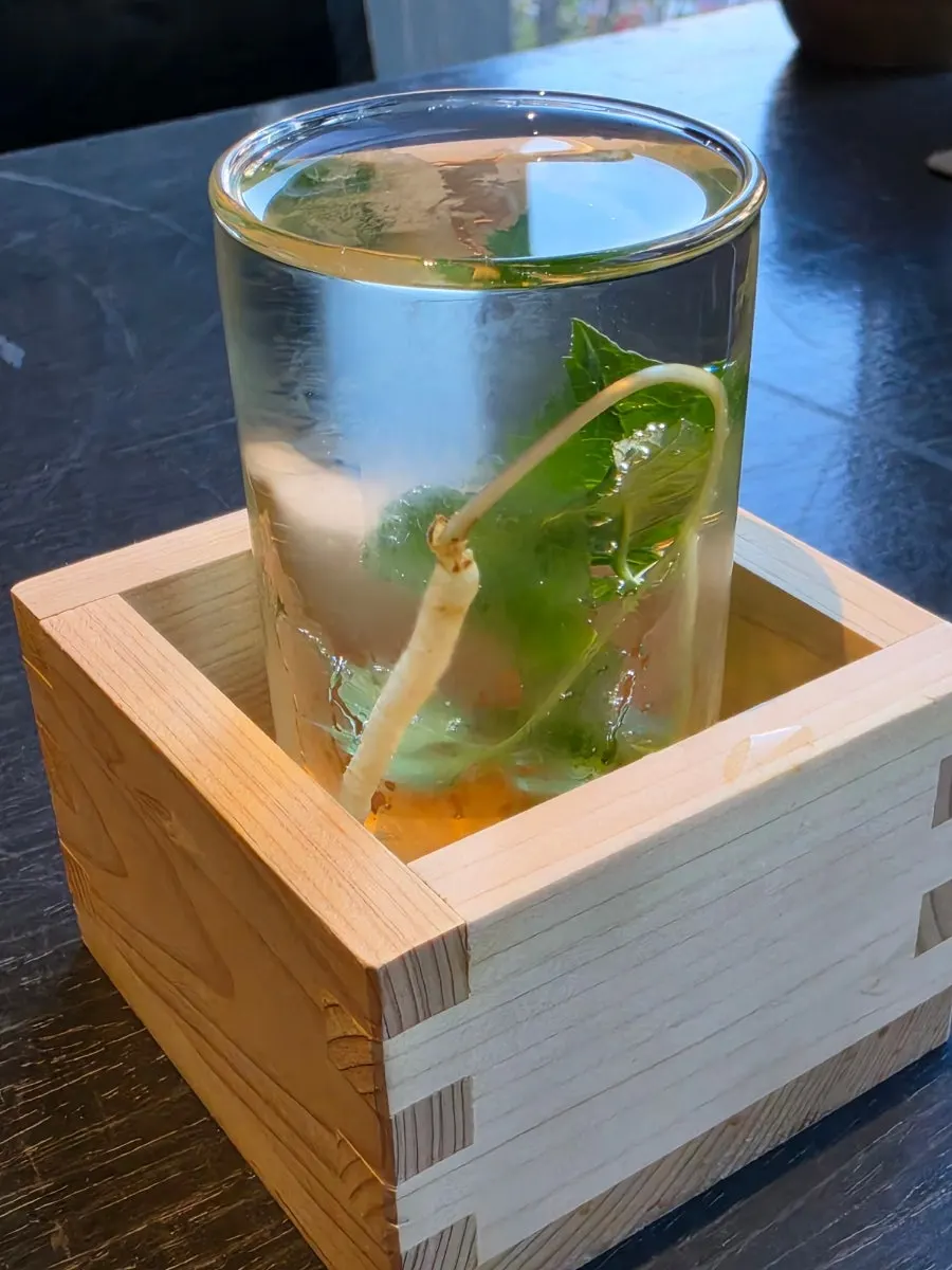 Bottle of Una ginseng liqueur with baby ginseng sprouts inside