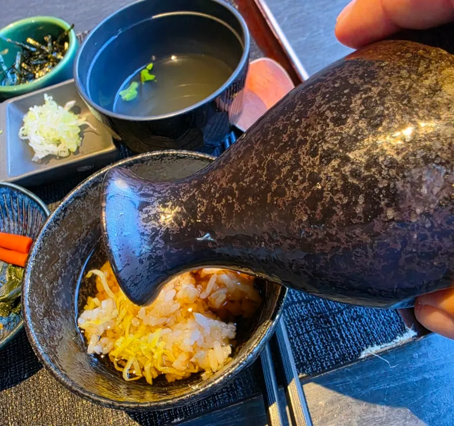 Ginseng liqueur filled to the brim in a cypress wood cup