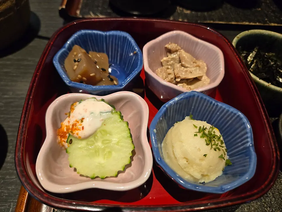 Four side dishes including muk, mushrooms, and sweet potato salad