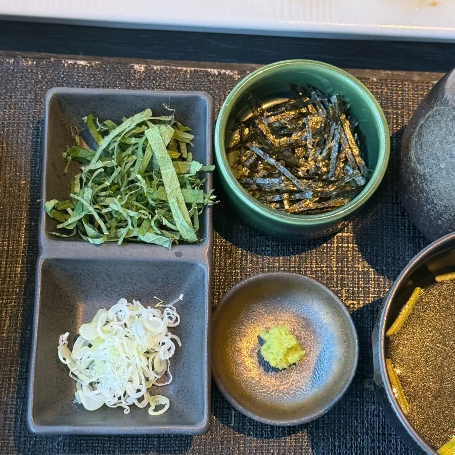 Bowl of perilla leaf, seaweed flakes, and green onion toppings