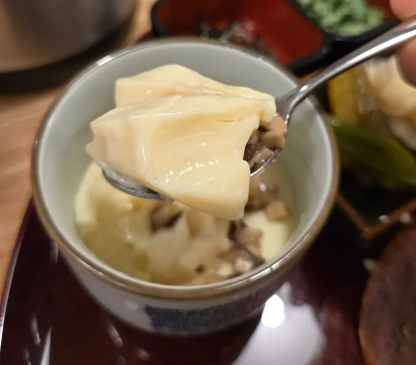 A bite of eel topped with umeboshi sauce