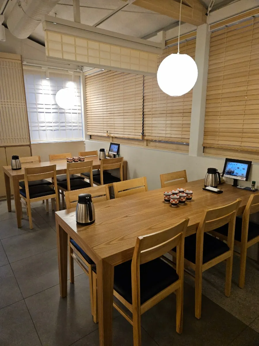 Overview of Unagiwa's hall with wooden tables