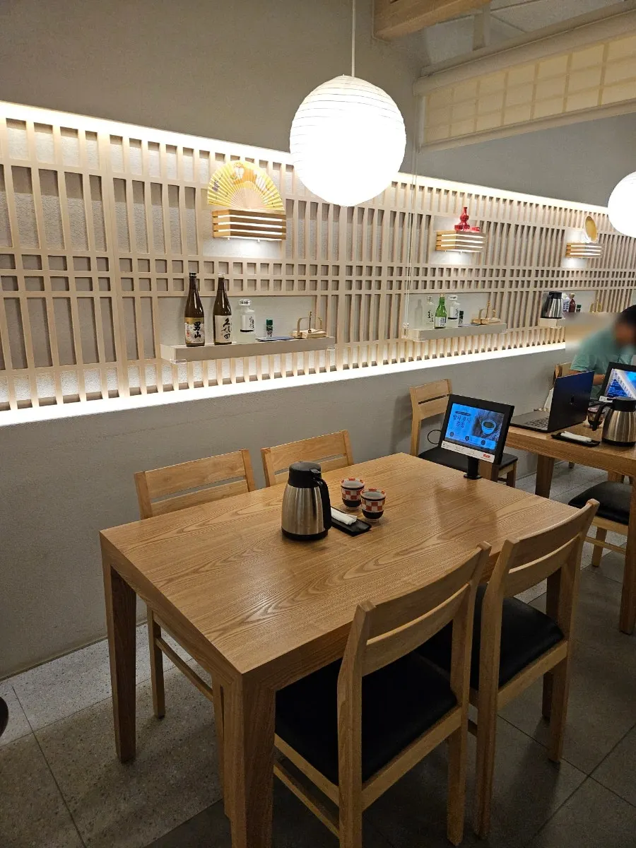 Hall seating lit by natural light through wooden blinds