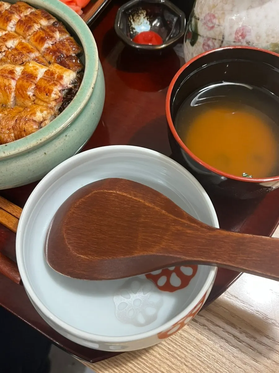 Close-up of Unagiwa's eel rice bowl topped with rice