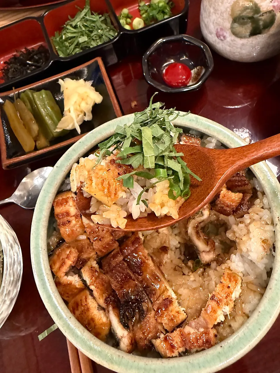 Eel rice bowl topped with perilla leaf and scallion