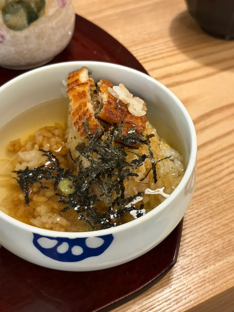 Eel rice bowl ochazuke with tea poured from a tokkuri