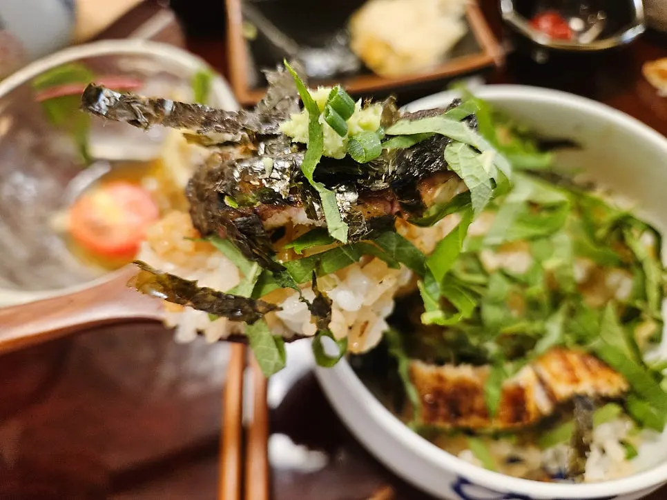 Side dish of scallion, perilla leaf, seaweed flakes, and wasabi