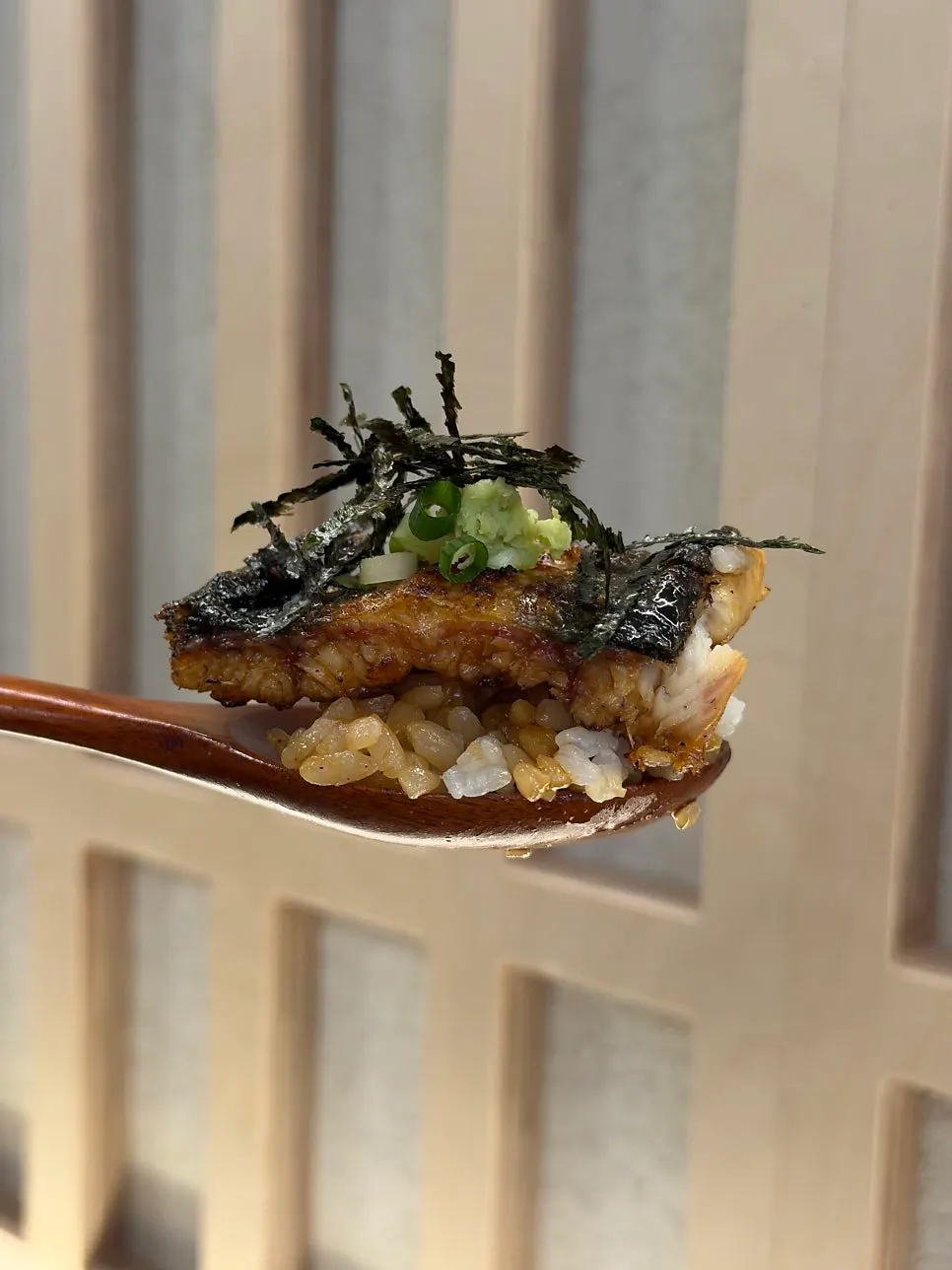 A piece of eel eaten with perilla leaf