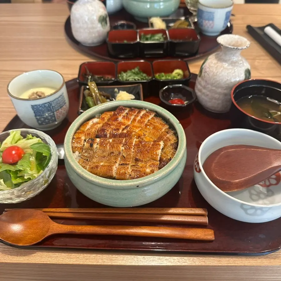 Hitsumabushi set table setting with chawanmushi and salad