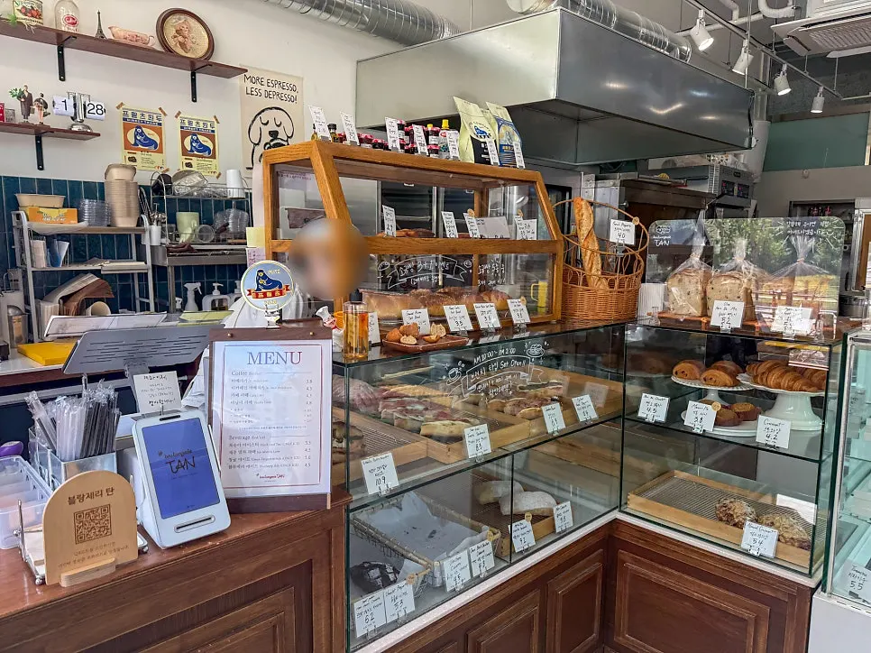 Interior of the shop with bread and sandwiches displayed in a wooden showcase